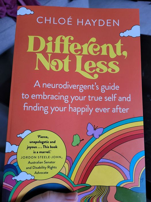 A copy of the book Different, Not Less by Chloé Hayden. A neurodivergent's guide to embracing your true self and finding your happily ever after.